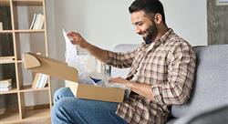 man opening a package at home